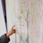 Tacks pinpoint multiple spots on a map of backcountry ski destinations at a photo presentation from Tony Doyle and Trent Sexton, Dec. 20 at the Kenai Visitors and Cultural Center. (Photo by Joey Klecka/Peninsula Clarion)