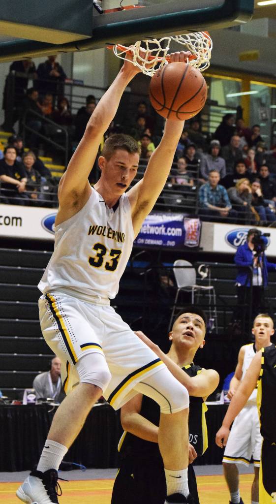 Ninilchik&rsquo;s Austin White puts down a two-handed dunk against the Aniak Halfbreeds, March 15, 2017, at the Class 1A state basketball tournament at the Alaska Airlines Center in Anchorage. (Photo by Joey Klecka/Peninsula Clarion)