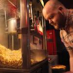 Orca Theatre manager Jordan Gruber makes popcorn for the next rush of movie-goers on Monday, Dec. 25, 2017 at the Orca Theatre on Kalifornsky Beach Road near Kenai, Alaska. (Photo by Ben Boettger/Peninsula Clarion)
