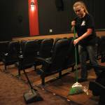 Orca Theatre manager Sarah Covault sweeps a theatre after a showing of &ldquo;Jumanji: Welcome to the Jungle&rdquo; on Monday, Dec. 25, 2017 at the Orca Theatre on Kalifornsky Beach Road near Kenai, Alaska. Covault said it&rsquo;s been a long time since she swept a theatre &mdash; as a manager, she usually delegates the job, but the employees (mostly high school-aged) had Christmas morning off. (Photo by Ben Boettger/Peninsula Clarion)