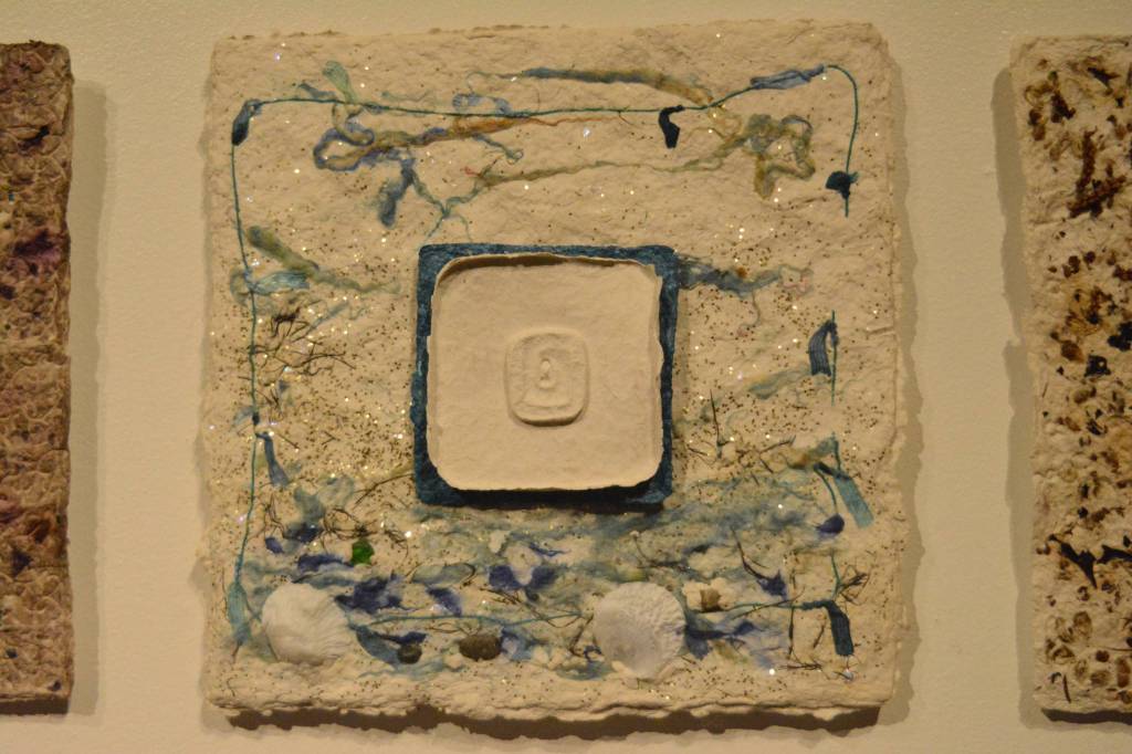 Ellen Lord&rsquo;s square is part of the Square Root of 49 piece that Lynn Marie Naden created. People contributed objects of personal meaning that Naden cast and included in parts of the art. (Photo by Michael Armstrong, Homer News)