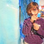 Alexandra Stoaks, 8, peers through a magnifying glass featured in one of the exhibits at the Kenai National Wildlife Refuge Visitor Center. Stoaks and her family attended the Dec. 27 Winter Break Family Fun Day at the center. The visitor center hosts community events throughout the year, including weekly winter walks and film screenings. (Photo by Erin Thompson/Peninsula Clarion)
