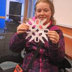 Audrey Larson, 13, shows off the paper snowflake she crafted while attending a family fun day at the Kenai National Wildlife Refuge Visitor Center on Dec. 27. (Photo by Erin Thompson/Peninsula Clarion)
