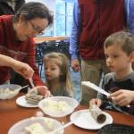 Marian Bowser helps grandchildren Finley, 3, and Tripp, 5, create a bird feeder during an afternoon of family-friendly events hosted by the Kenai National Wildlife Refuge Visitor Center on Dec. 27. (Photo by Erin Thompson/Peninsula Clarion)