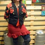 Artist Julianne Tomich stands next to one of her bear paintings at the First Friday opening of her show at Grace Ridge Brewery. (Photo by Michael Armstrong, Homer News)