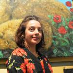 Artist Julianne Tomich stands next to one of her bear paintings at the First Friday opening of her show at Grace Ridge Brewery. (Photo by Michael Armstrong, Homer News)