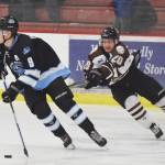 Kenai River forward Tyler Miknich (right) tries to get a stick on Coulee Region defenseman Marshal Plunkett Friday night at the Soldotna Regional Sports Complex. (Photo by Joey Klecka/Peninsula Clarion)
