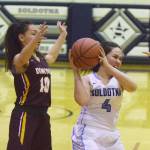 Soldotna senior Mei Miller fights to keep the ball from Dimond sophomore Angelline Nageak (left) Saturday night at Soldotna High School. (Photo by Joey Klecka/Peninsula Clarion)