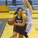 Dimond junior Alyssa Pili works her way around Soldotna junior Danica Schmidt (right) Saturday night at Soldotna High School. (Photo by Joey Klecka/Peninsula Clarion)