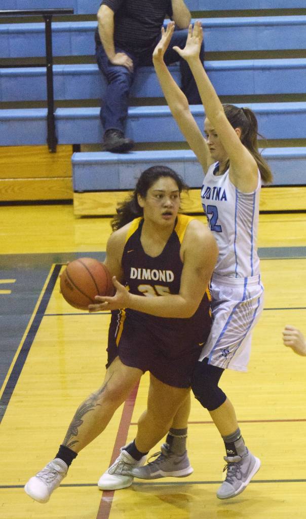 Dimond junior Alyssa Pili works her way around Soldotna junior Danica Schmidt (right) Saturday night at Soldotna High School. (Photo by Joey Klecka/Peninsula Clarion)