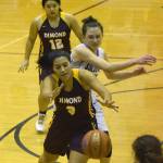 Dimond senior Maya Carle chases after the ball with Soldotna junior Aliann Schmidt (right) Saturday night at Soldotna High School. (Photo by Joey Klecka/Peninsula Clarion)