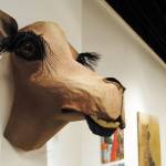 Kenai Peninsula Borough School District teacher Andrea Eggleston&rsquo;s work &lsquo;The Grin&rsquo; hangs at the Kenai Fine Arts Center in Kenai for the January exhibit which features art from teachers across the school district. (Photo by Kat Sorensen/Peninsula Clarion)