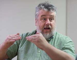 Patrick Sidmore, a health planner for the Alaska Mental Health Board, talks on Tuesday, Jan. 9, 2018, about new studies in addressing emotional trauma in young students. (Michael Penn | Juneau Empire)