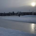 A Soldotna Parks & Recreation worker sprays a layer of water to be frozen into a skating rink Thursday at Soldotna Creek Park. (Photo by Joey Klecka/Peninsula Clarion)
