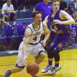 Soldotna senior Caleb Spence (left) works up the baseline by Kodiak&rsquo;s Louis Rocheleau Thursday night at Soldotna High School. (Photo by Joey Klecka/Peninsula Clarion)