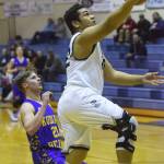 Soldotna senior Wendell Tuisaula drives to the rim ahead of Kodiak&rsquo;s Wesley Walker (left) Thursday night at Soldotna High School. (Photo by Joey Klecka/Peninsula Clarion)