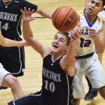 Nikiski senior Ian Johnson (10) corrals a loose ball Friday night against Monroe Catholic at the Rus Hitchcock Nikiski Tip-Off Tournament in Nikiski. (Photo by Joey Klecka/Peninsula Clarion)