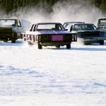 Drivers skid around one of the corners on the ice track atop a frozen lake at the Decanter Inn on Sunday, Jan. 22, 2018 in Kasilof, Alaska. Every Sunday in the winter, the Decanter Inn hosts Peninsula Ice Racing events for drivers to try their hand at the frozen track on the shallow lake at the bottom of the hill behind the inn. The racers can use studded tires on their front wheels only and equip the sides of their vehicles with bumpers as other vehicles are likely to slip and slide into them. Spinning out is common. A tow truck waits on the sidelines to retrieve drivers who get stuck on the berms alongside the track. Fans gathered Sunday despite the cold to cheer the racers on. The men race in the morning, followed by the women&rsquo;s races in the afternoon. (Photo by Elizabeth Earl/Peninsula Clarion)