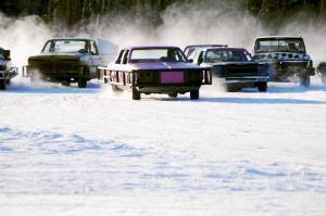 Drivers skid around one of the corners on the ice track atop a frozen lake at the Decanter Inn on Sunday, Jan. 22, 2018 in Kasilof, Alaska. Every Sunday in the winter, the Decanter Inn hosts Peninsula Ice Racing events for drivers to try their hand at the frozen track on the shallow lake at the bottom of the hill behind the inn. The racers can use studded tires on their front wheels only and equip the sides of their vehicles with bumpers as other vehicles are likely to slip and slide into them. Spinning out is common. A tow truck waits on the sidelines to retrieve drivers who get stuck on the berms alongside the track. Fans gathered Sunday despite the cold to cheer the racers on. The men race in the morning, followed by the women&rsquo;s races in the afternoon. (Photo by Elizabeth Earl/Peninsula Clarion)