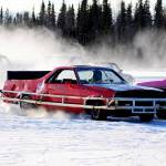 A racecar driver passes the crowd of competitors on the ice track atop a frozen lake at the Decanter Inn on Sunday, Jan. 22, 2018 in Kasilof, Alaska. Every Sunday in the winter, the Decanter Inn hosts Peninsula Ice Racing events for drivers to try their hand at the frozen track on the shallow lake at the bottom of the hill behind the inn. The racers can use studded tires on their front wheels only and equip the sides of their vehicles with bumpers as other vehicles are likely to slip and slide into them. Spinning out is common. A tow truck waits on the sidelines to retrieve drivers who get stuck on the berms alongside the track. Fans gathered Sunday despite the cold to cheer the racers on. The men race in the morning, followed by the women&rsquo;s races in the afternoon. (Photo by Elizabeth Earl/Peninsula Clarion)