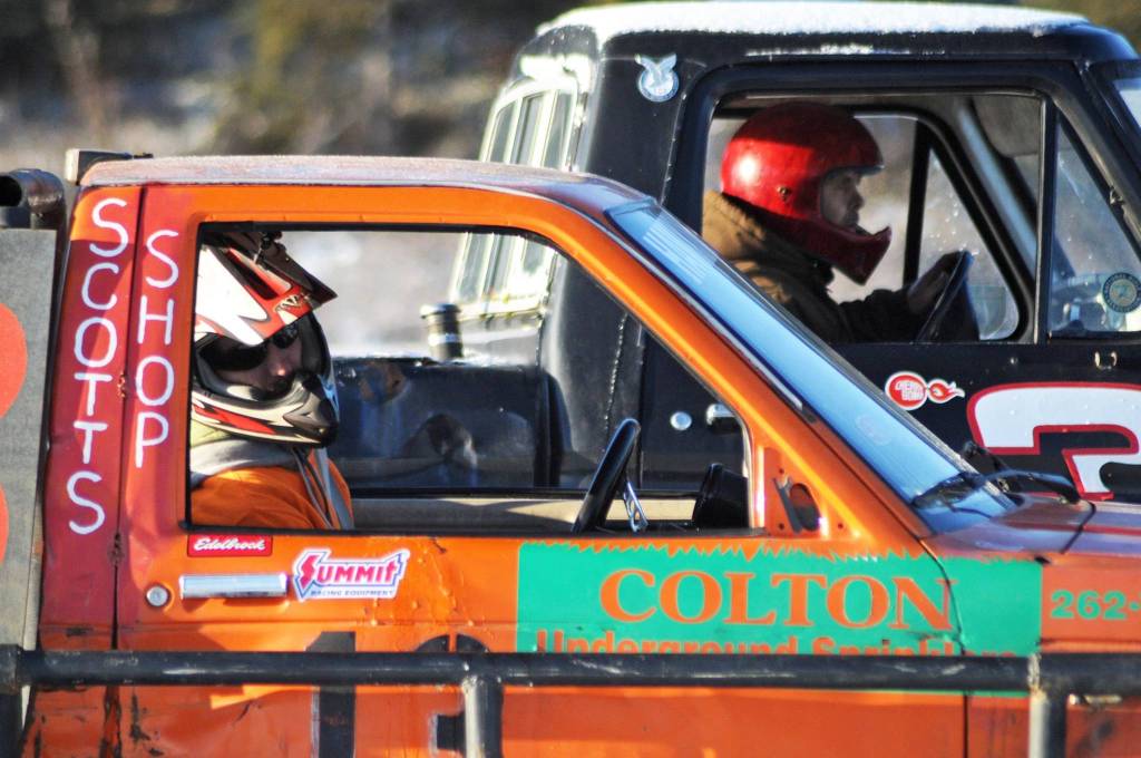 Racecar drivers wait for the flag to drop before a race on the ice track atop a frozen lake at the Decanter Inn on Sunday, Jan. 22, 2018 in Kasilof, Alaska. Every Sunday in the winter, the Decanter Inn hosts Peninsula Ice Racing events for drivers to try their hand at the frozen track on the shallow lake at the bottom of the hill behind the inn. The racers can use studded tires on their front wheels only and equip the sides of their vehicles with bumpers as other vehicles are likely to slip and slide into them. Spinning out is common. A tow truck waits on the sidelines to retrieve drivers who get stuck on the berms alongside the track. Fans gathered Sunday despite the cold to cheer the racers on. The men race in the morning, followed by the women&rsquo;s races in the afternoon. (Photo by Elizabeth Earl/Peninsula Clarion)