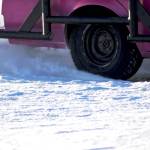A racecar driver kicks up snow as he skids around one of the corners on the ice track atop a frozen lake at the Decanter Inn on Sunday, Jan. 22, 2018 in Kasilof, Alaska. Every Sunday in the winter, the Decanter Inn hosts Peninsula Ice Racing events for drivers to try their hand at the frozen track on the shallow lake at the bottom of the hill behind the inn. The racers can use studded tires on their front wheels only and equip the sides of their vehicles with bumpers as other vehicles are likely to slip and slide into them. Spinning out is common. A tow truck waits on the sidelines to retrieve drivers who get stuck on the berms alongside the track. Fans gathered Sunday despite the cold to cheer the racers on. The men race in the morning, followed by the women&rsquo;s races in the afternoon. (Photo by Elizabeth Earl/Peninsula Clarion)