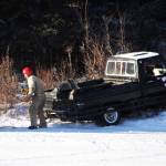 A tow truck prepares to pull a racecar driver back onto the ice track atop a frozen lake at the Decanter Inn on Sunday, Jan. 22, 2018 in Kasilof, Alaska. Every Sunday in the winter, the Decanter Inn hosts Peninsula Ice Racing events for drivers to try their hand at the frozen track on the shallow lake at the bottom of the hill behind the inn. The racers can use studded tires on their front wheels only and equip the sides of their vehicles with bumpers as other vehicles are likely to slip and slide into them. Spinning out is common. A tow truck waits on the sidelines to retrieve drivers who get stuck on the berms alongside the track. Fans gathered Sunday despite the cold to cheer the racers on. The men race in the morning, followed by the women&rsquo;s races in the afternoon. (Photo by Elizabeth Earl/Peninsula Clarion)