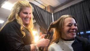 In this 2016 file photo, volunteer hairdresser Joy Conner (left) curls the hair of Alison Alley during Project Homeless Connect, an event at which local individuals and organizations provided information and services to the Kenai Peninsula community members experiencing homelessness. This year&rsquo;s event will once again provide haircuts, massages, food, and veterinary care on Jan. 24 at the Soldotna Regional Sports Complex. (Photo by Ben Boettger/Peninsula Clarion)