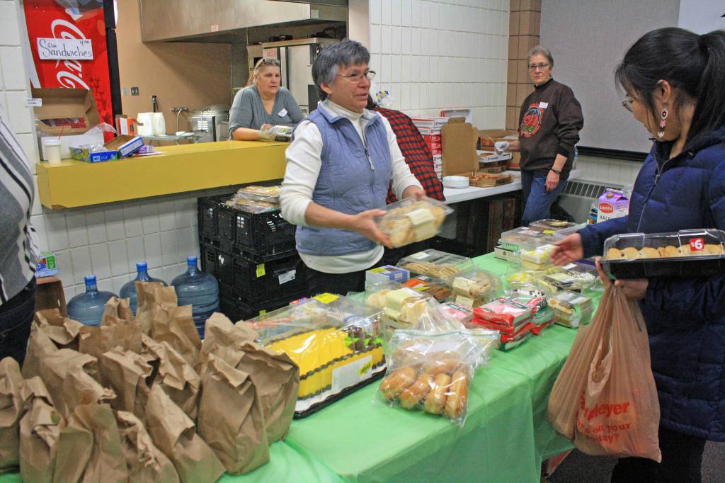 Volunteers staff the kitchen and buffet line at the Jan. 24 Project Homeless Connect at the Soldotna Regional Sports Complex. The annual event gathers service providers, nonprofits and volunteers to support members of the homeless community and those in need. (Photo by Erin Thompson/Peninsula Clarion)