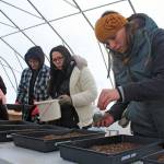 Jasmine Koster, right, plants seeds during at the Dena&rsquo;ina Wellness Center greenhouse on Thursday, Jan. 25. The wellness center hosted a workshop on how to germinate local seeds traditionally. (Photo by Erin Thompson/Peninsula Clarion)