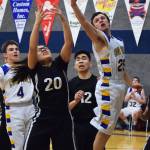 Cook Inlet&rsquo;s James Anderson contends with Kodiak ESS&rsquo;s Teanna Amodo (20) for a rebound Thursday night at Cook Inlet Academy in Soldotna. (Photo by Joey Klecka/Peninsula Clarion)