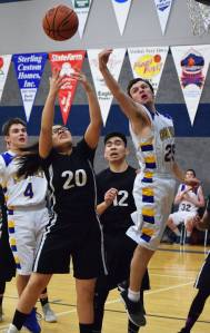 Cook Inlet&rsquo;s James Anderson contends with Kodiak ESS&rsquo;s Teanna Amodo (20) for a rebound Thursday night at Cook Inlet Academy in Soldotna. (Photo by Joey Klecka/Peninsula Clarion)
