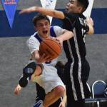 Cook Inlet&rsquo;s Hunter Moos (left) evades the block from Kodiak ESS defender Travis Amodo Thursday night at Cook Inlet Academy in Soldotna. (Photo by Joey Klecka/Peninsula Clarion)