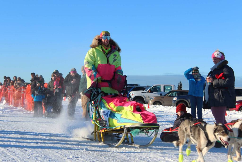 Monica Zappa, in her telltale neon garb, takes off with her team from the starting line of this year&rsquo;s Tustumena 200 Sled Dog Race on Saturday, Jan. 27, 2018 at Freddie&rsquo;s Roadhouse in Ninilchik, Alaska. (Photo by Megan Pacer/Homer News)