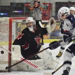 Kenai Central goaltender Josh Tree wards off a puck from a Soldotna defenseman Saturday night at the Soldotna Regional Sports Complex. (Photo by Joey Klecka/Peninsula Clarion)