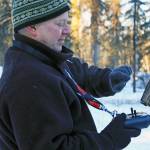Kenai National Wildlife Refuge ecologist Mark Laker preps a 3DR surveillance drone equipped with a heat sensor during a prescribed burning on Thursday, Feb. 1. The burning is part of a hazardous fuel reduction project being carried out by the refuge. (Photo by Erin Thompson/Peninsula Clarion)