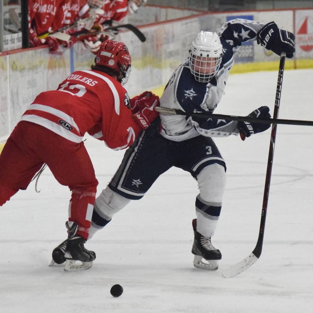 Soldotna skater Galen Brantley III darts by Wasilla&rsquo;s Slayte Wohlers (left) Thursday night in a North Star Conference tournament semifinal at the Soldotna Regional Sports Complex. (Photo by Joey Klecka/Peninsula Clarion)