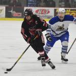 Kenai Central&rsquo;s Matt Hagel (22) streaks down the ice in front of Palmer skater RJ Avezac Thursday evening in a North Star Conference tournament semifinal at the Soldotna Regional Sports Complex. (Photo by Joey Klecka/Peninsula Clarion)