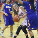 Kenai Central&rsquo;s Brooke Satathite tries to get a shot off between Kodiak&rsquo;s Ruth DelaCruz and Norvellisa Marcelo on Friday, Feb. 2, 2018, at Kenai Central High School. (Photo by Jeff Helminiak/Peninsula Clarion)