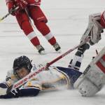 Homer&rsquo;s Tim Blakely slides into Wasilla goaltender Aaron Campbell Friday in a North Star Conference tournament semifinal at the Soldotna Regional Sports Complex. (Photo by Joey Klecka/Peninsula Clarion)
