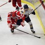 Wasilla&rsquo;s Porter Schachle (left) battles with Lee Lowe for the puck Friday in a North Star Conference tournament semifinal at the Soldotna Regional Sports Complex. (Photo by Joey Klecka/Peninsula Clarion)