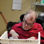 Chuck Davis shreds paper at the Frontier Community Services office in Soldotna on Jan. 18, 2018, his last day of work after 33 years with the non-profit agency. (Photo by Kat Sorensen/Peninsula Clarion)