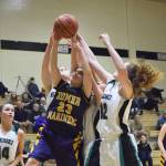 Homer&rsquo;s Maggie Box (23) battles for a rebound with Nikiski&rsquo;s Kaycee Bostic (right) Saturday at Nikiski High School. (Photo by Joey Klecka/Peninsula Clarion)