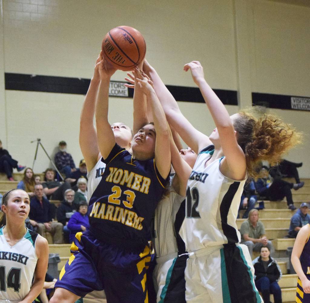 Homer&rsquo;s Maggie Box (23) battles for a rebound with Nikiski&rsquo;s Kaycee Bostic (right) Saturday at Nikiski High School. (Photo by Joey Klecka/Peninsula Clarion)