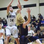 Nikiski&rsquo;s Garrett Ellis (14) fights for a rebound with Homer&rsquo;s Charles Rohr (0) Saturday at Nikiski High School. (Photo by Joey Klecka/Peninsula Clarion)
