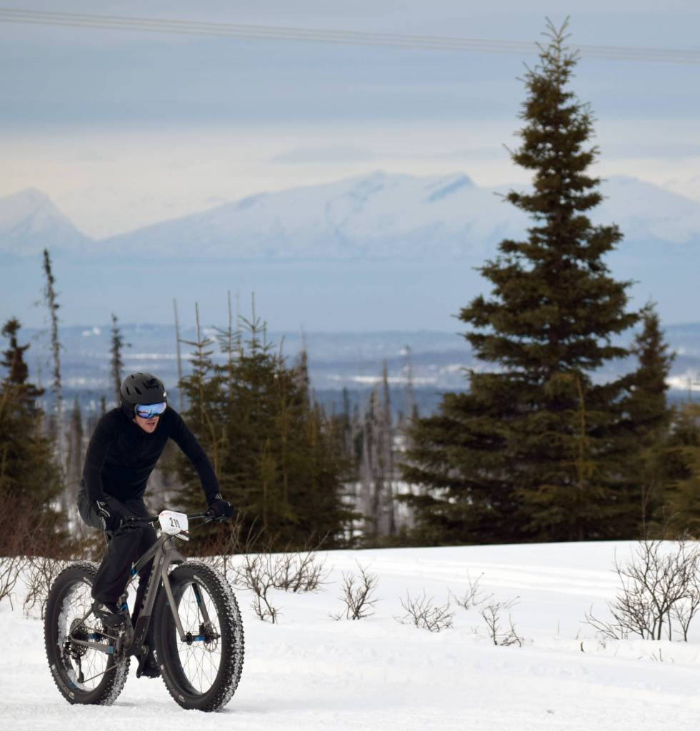 Men&rsquo;s winner Mike Crawford crests a hill during Fat Freddie&rsquo;s Bike Race and Ramble on Saturday, Feb. 10, 2018, in the Caribou Hills. (Photo by Jeff Helminiak/Peninsula Clarion)