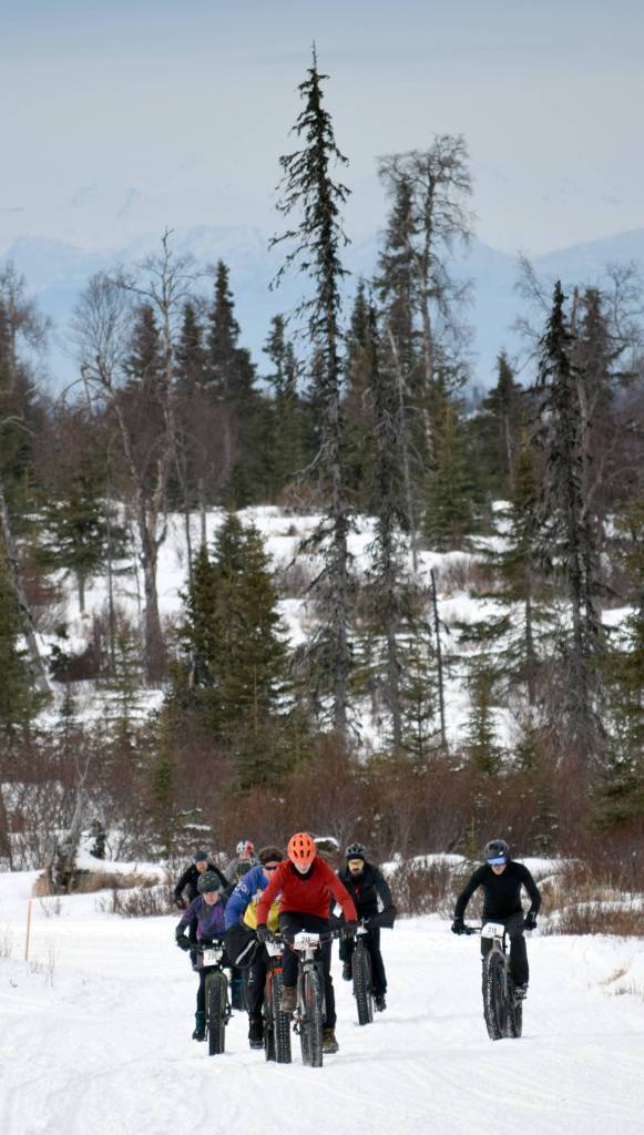 Tyle Owens leads the first group of riders up a hill at the start of Fat Freddie&rsquo;s Bike Race and Ramble on Saturday, Feb. 10, 2018, in the Caribou Hills. (Photo by Jeff Helminiak/Peninsula Clarion)