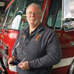 Kenai Fire Chief Jeff Tucker shows off the 2017 Warren B. Cummings Chief Officer of the Year Award at the Kenai Fire Station on Feb. 12. The award recognizes Tucker&rsquo;s leadership success and contributions to the Alaska fire service. (Photo by Erin Thompson/Peninsula Clarion)