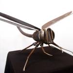 ABOVE: Dave Emery&rsquo;s &ldquo;Medium Dragonfly&rdquo; is on display in the Kenai Visitor&rsquo;s Center in Kenai as part of the Metal Masters winter exhibit. (Photo by Kat Sorensen/Peninsula Clarion) TOP: Scott Hamann&rsquo;s piece &ldquo;Raven Moon&rdquo; depicts a copper raven on an illuminated moon. The piece is hanging in the Kenai Visitor&rsquo;s Center in Kenai as part of the Metal Masters winter exhibit. (Photo by Kat Sorensen/Peninsula Clarion)