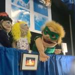 Anya Hondel performs &ldquo;Capt&rsquo;n Conservation: Saving Energy One Lightbulb at a Time,&rdquo; a puppet show which focuses on energy conservation, at Wednesday&rsquo;s joint Kenai/Soldotna Chamber of Commerce luncheon. The project, which is accompanied by a coloring book and website, took home top prize during 2017&rsquo;s Caring for the Kenai Competition. The competition asks students to think outside the box to solve issues facing their community and is hoping to expand beyond the peninsula with &ldquo;Caring for my Backyard,&rdquo; a community partnership available anywhere there are backyards and youth with creative ideas . (Photo by Kat Sorensen/Peninsula Clarion)